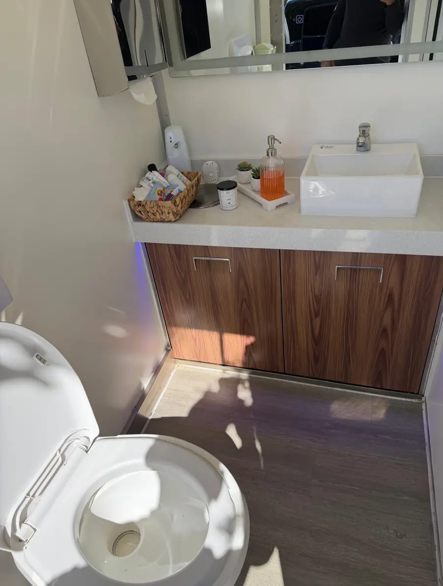 Restroom trailer vanity with vessel sink and soap